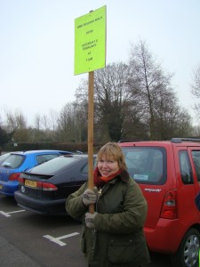 Hilary holding a board to mark the start of the boards walk